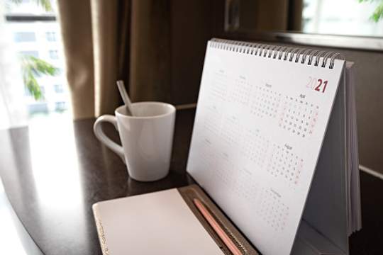 desk calendar next to coffee cup